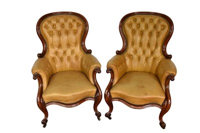 Lot 1060 - Pair of Victorian button leather upholstered armchairs, each with spoon shaped back and showwood frame on castors