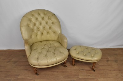 Lot 1062 - Victorian style button leather tub chair and en-suite footstool, raised on turned oak legs and castors