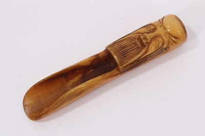 Lot 744 - Chinese carved horn tea scoop, with carved mask decoration, 13.5cm in length.