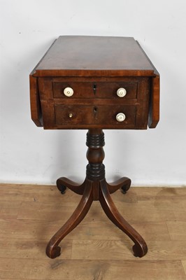 Lot 1100 - Regency mahogany work table, with rosewood crossbanded drop leaf top and two drawers and opposing dummy drawers on turned column and quadruped scrolled supports on castors, 47 x 31cm