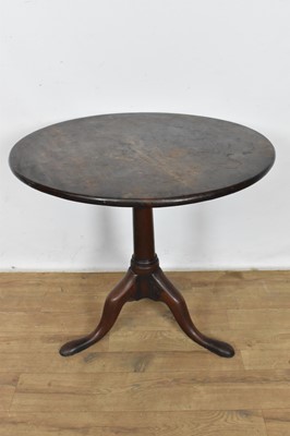 Lot 1108 - George II mahogany occasional table, with solid circular tilt top on gun barrel column and tripod cabriole legs, 76cm diameter