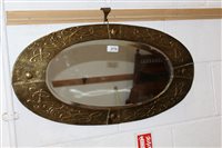 Lot 2779 - Arts & Crafts oval mirror with brass repoussé...