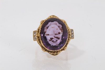 Lot 431 - Amethyst and diamond ring with a large oval mixed cut amethyst in gold setting, diamond set shoulders on gold shank