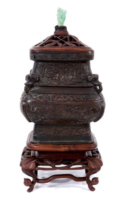 Lot 714 - Antique Chinese bronze pot with a later carved wooden lid with jade finial, on a carved wooden stand