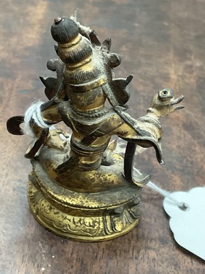 Lot 687 - Early miniature Tibetan gilt bronze deity figure, together with a Chinese gilt bronze deity figure on lotus base