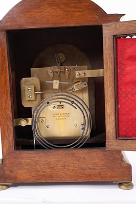 Lot 620 - Good quality late Victorian bracket clock by John Carter, London with fusee movement striking on gong, silvered arched dial with floral scrollwork and strike / silent to arch in brass inlaid oak do...