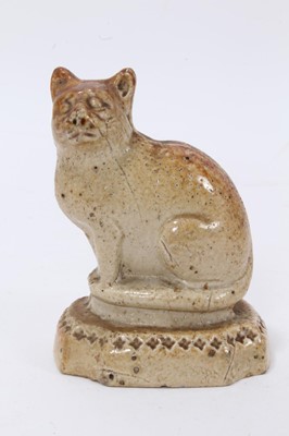 Lot 18 - A Victorian salt-glazed stoneware model of a cat, seated on a cushion base, 7.5cm high