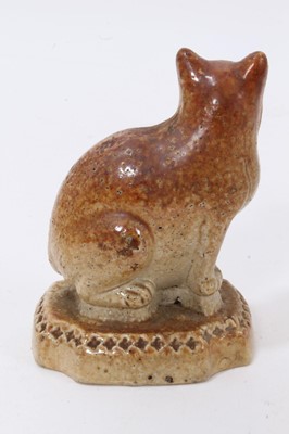 Lot 18 - A Victorian salt-glazed stoneware model of a cat, seated on a cushion base, 7.5cm high
