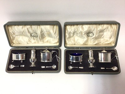 Lot 255 - A pair of three piece condiment sets, comprising salt, pepper and mustard with matching spoons