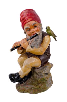 Lot 119 - Austrian terracotta garden gnome seated playing a flute, with polychrome painted decoration.