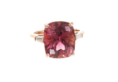 Lot 457 - Pink tourmaline and diamond ring with a rectangular cushion cut pink tourmaline estimated to weigh approximately 6.74cts, flanked by two tapered baguette cut diamonds to the shoulders on 18ct rose...