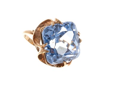 Lot 459 - Synthetic blue spinel cocktail ring with a large cushion cut stone in 9ct yellow gold setting, ring size M½.