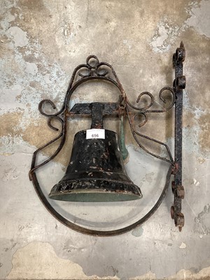 Lot 656 - Large bell on black painted wrought iron wall mount