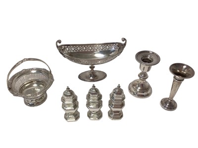 Lot 307 - Two silver bon bon baskets, set three silver pepper pots, silver candlestick and spill vase (7) 17ozs weighable silver