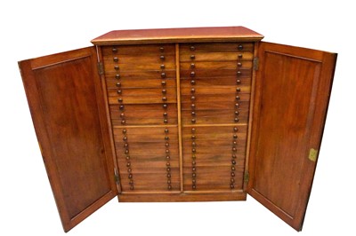 Lot 1604 - 19th century mahogany floor standing collector’s cabinet, with an arrangement of forty drawers in two banks, enclosed by pair of arched panel doors, on plinth base