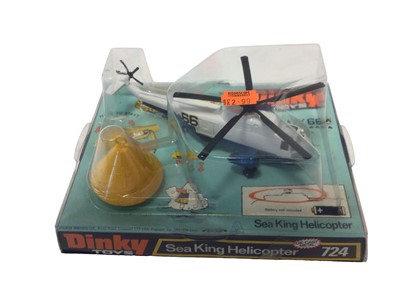 Lot 12 - Dinky Beechcraft C55 Baron No.715, Bell Police Helicopter No.732, Sea King Helicopter No.724, Hawker Harrier No.722, all in bubble pack and base (4)