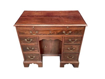 Lot 1232 - George III kneehole dressing table, with moulded top and dressing slide over one long and six short drawers, with flush shaped drawer and cupboard to the kneehole, on bracket feet, 88cm wide x 41cm...