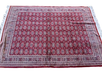 Lot 1259 - Part silk Bokhara style rug, having eight rows of eighteen quartered medallions in geometric borders 190 x 140cm, together with a modern Persian rug, 160 x 117cm