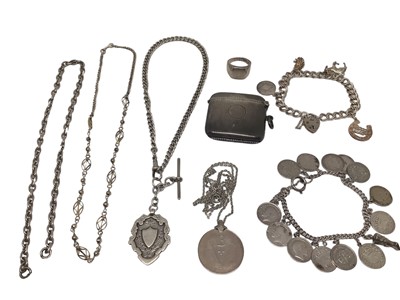 Lot 264 - Group of silver jewellery, including a charm bracelet, coin bracelet, vesta case, watch chain