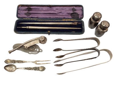 Lot 1033 - Group of silver including three pairs of sugar tongs, pair of pepperettes, spoon and fork set, pen and pencil set in fitted case and a silver plated bosun's whistle