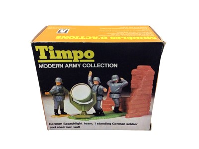 Lot 128 - Timpo Modern Army Collection including German Stretcher Team, Parachutist and Tree & German Searchlight Team, 1 standing German Soldier and shell torn wall, both boxed (2)