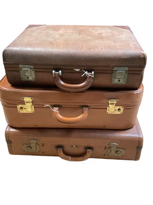 Lot 2064 - Three vintage suitcases to include two brown leather cases (3)