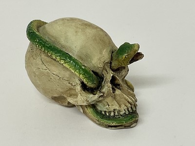 Lot 81 - Small skull with snake running through its open mouth