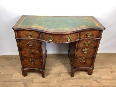 Lot 1589 - 1920s walnut kneehole desk with serpentine front, leather top and nine drawers, together with a Georgian walnut elbow chair (2)