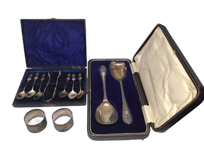 Lot 251 - Pair of 1920s silver serving spoons in fitted case, pair of silver napkin rings and a cased set of silver plated Apostle spoons and pair of sugar tongs