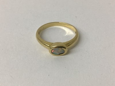 Lot 83 - 18ct gold and single stone opal ring