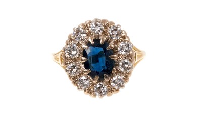 Lot 738 - Sapphire and diamond cluster ring with an oval mixed cut blue sapphire measuring approximately 8 x 5.9mm surrounded by ten brilliant cut diamonds in claw setting on 18ct gold shank. Estimated total...