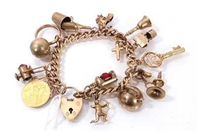 Lot 842 - Gold charm bracelet with a collection of 9ct gold charms and a gold half sovereign