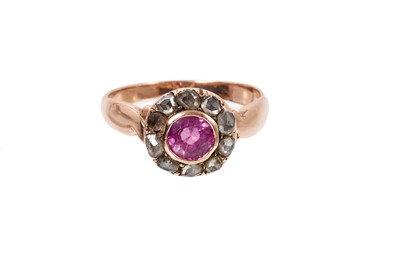 Lot 771 - Antique pink sapphire and diamond cluster ring with a central round mixed cut pink sapphire measuring approximately 5mm surrounded by a border of ten rose cut diamonds with pierced gold gallery on...