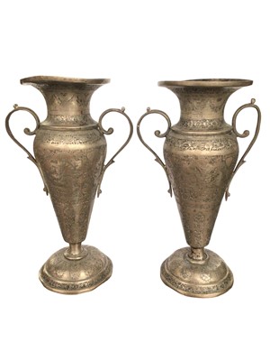 Lot 216 - Pair of Persian white metal double handled vases with floral, bird and animal decoration, 15.5cm high