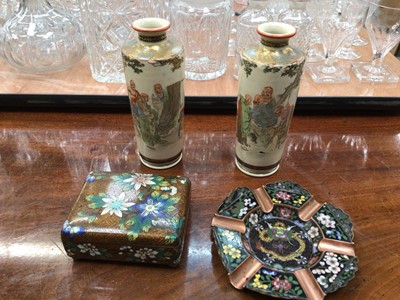 Lot 99 - Pair of Japanese Meiji period Satsuma pottery vases, decorated with Immortals, signed to base, together with a cloisonné box and ashtray (4)