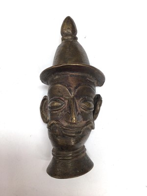 Lot 405 - Tibetan or Eastern bronze head, possibly a staff capital