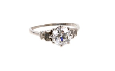 Lot 745 - Art Deco diamond single stone ring with baguette cut diamonds to the stepped shoulders