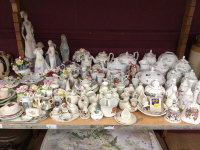 Lot 746 - Lladro figures, flower ornaments, porcelain bells, crested ware etc - 1 shelf