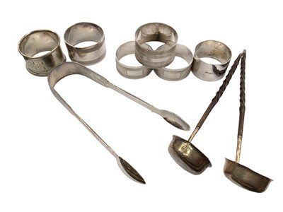 Lot 1069 - Pair of silver sugar tongs, two silver toddy labels with bone handles, four silver napkin rings and two plated