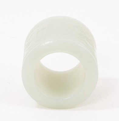 Lot 1046 - Chinese celadon jade archer's ring, relief carved with character marks