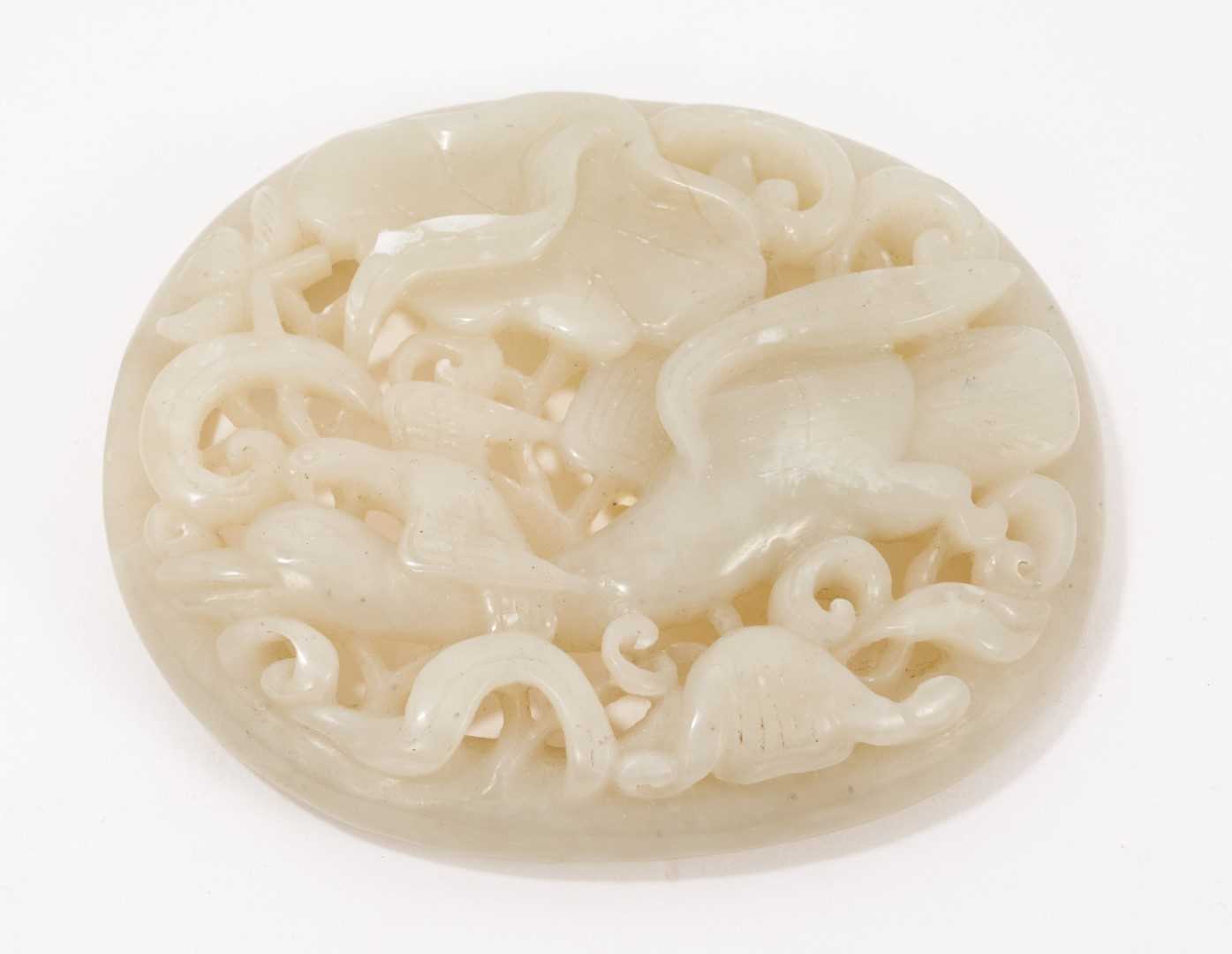 Lot 1043 - Chinese pale celadon jade plaque, carved and pierced with birds and foliate patterns