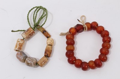 Lot 1044 - Chinese jade bead bracelet, possibly archaic, and a Chinese agate bracelet