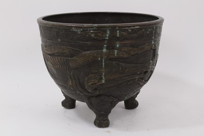 Lot 1051 - A Japanese bronze footed bowl, decorated in relief with birds, character mark to base, 22.5cm high