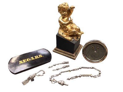 Lot 1078 - Works of art including gilt seated putto figure, papier-mâché 'Segar' case, white metal photo frame and a white metal watch chain with acorn whistle fob