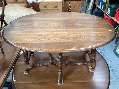 Lot 1208 - Ercol elm oval drop leaf coffee table on turned and block legs joined by stretchers