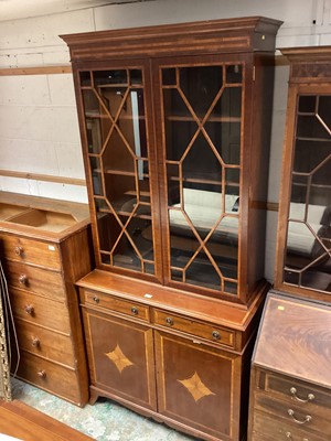 Lot 1295 - Mahogany crossbanded bookcase, the glazed top above two drawers with cupboards below