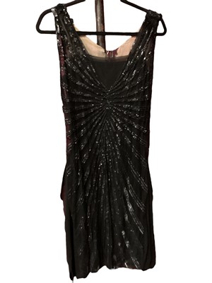 Lot 2054 - Edwardian black silk evening coat with purple silk lining, 1920s black silk crepe evening dress with beaded overlay, black wool beaded cocktail dress with gathered detail to front, wide purple and...