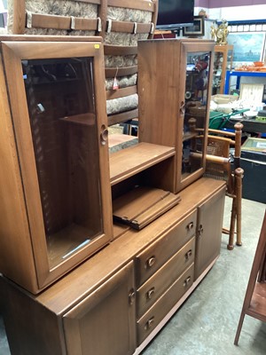 Lot 1229 - Ercol elm two height sideboard with central shelves above flanked by two glazed cabinets, three central drawers and two doors below, 155cm wide, 43cm deep, 161cm high