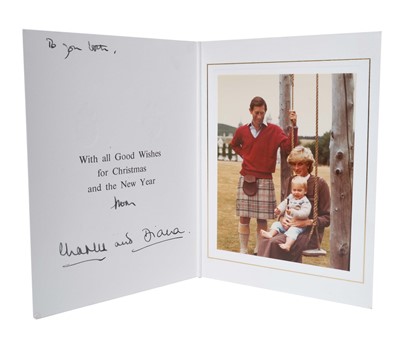 Lot 14 - T.R.H. The Prince and Princess of Wales, signed 1983 Christmas card, with twin gilt ciphers to cover, colour photograph of the happy couple at Balmoral with the infant Prince William on a swing