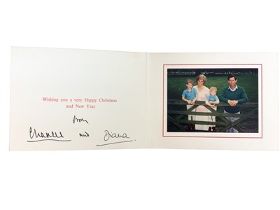 Lot 19 - T.R.H. The Prince and Princess of Wales, signed 1989 Christmas card, with twin gilt ciphers to cover, colour photograph of the Royal couple with their young sons resting on a gate